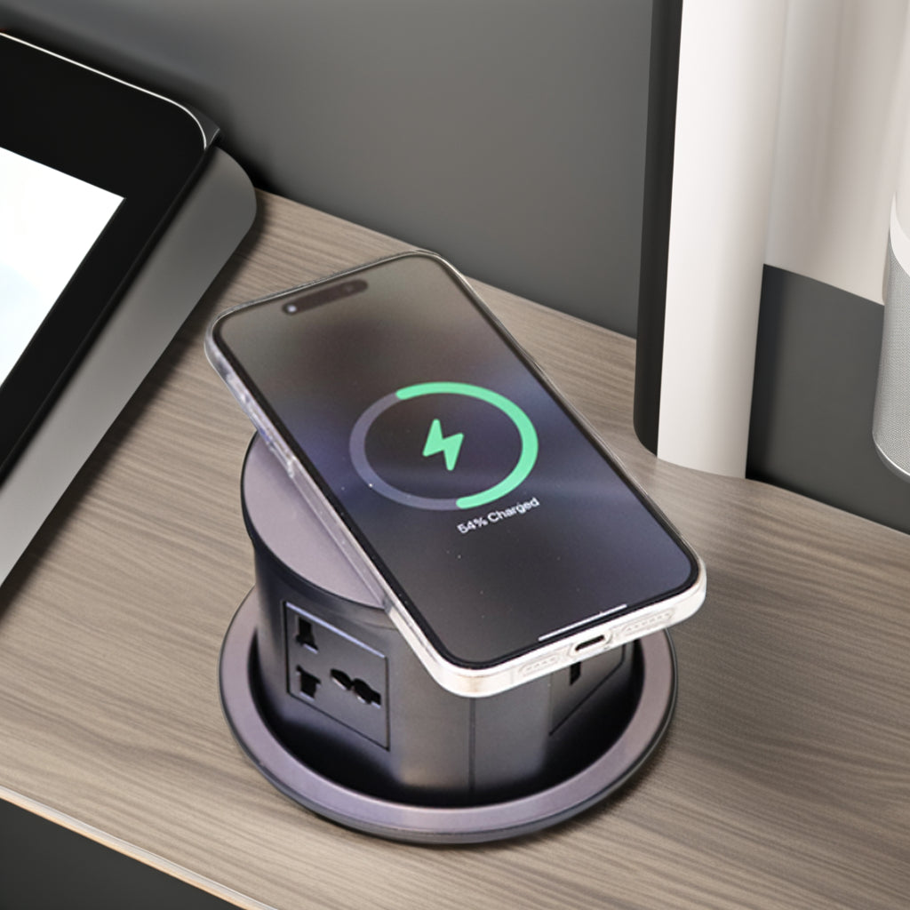 Phone charging on a multi-device charging station with a tablet and laptop in the background.